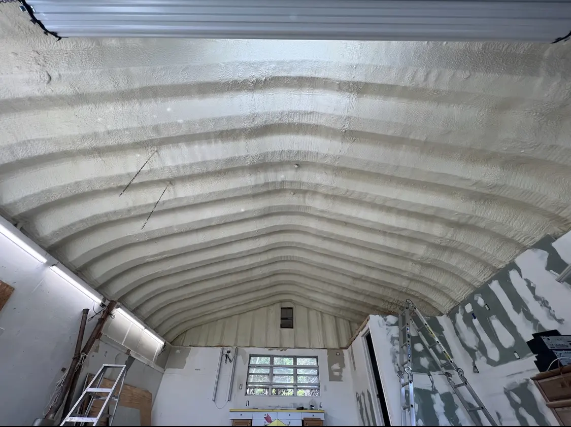 Spray polyurethane foam applied to the underside of a metal roof deck in Holly Springs